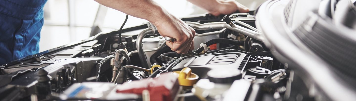 Mechanic working on a car engine