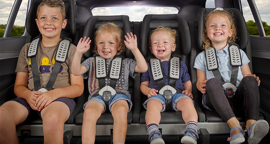 Four children in Multimac car seats across one car row